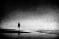 Lonely woman walking on beach with grungy textures Royalty Free Stock Photo