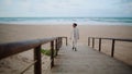 Lonely woman walking beach wooden pathway. Serene african american enjoy time Royalty Free Stock Photo