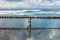 Lonely woman walking on ocean beach Royalty Free Stock Photo