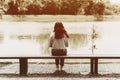 Lonely women sitting at bench alone in the park back view Royalty Free Stock Photo