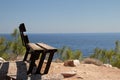 Lonely wooden bench at the cliff over the sea side Royalty Free Stock Photo