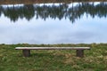 Lonely wooden bench by the lake Royalty Free Stock Photo