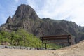 Lonely wooden bench in the mountain in relax and peaceful view point. Place to rest and calm spot with great peak and empty sea Royalty Free Stock Photo