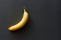 Lonely Yellow banana on a black background