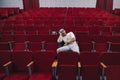 A lonely young man in an empty theater fell asleep at the performance. An uninteresting boring opera.. man with glasses Royalty Free Stock Photo