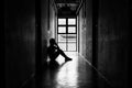 Lonely young man feeling depressed and stressed sitting in the dark walkway, Negative emotion and mental health concept Royalty Free Stock Photo