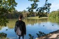 Lonely young man standing in front of a lake in germany.