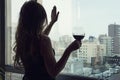 Lonely young woman at home drinking alcohol. Female alcoholism. single luxury beautiful woman in black dress with wine