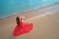 Lonely young woman sitting on ocean sandy beach by seaside enjoying warm tropical evening Royalty Free Stock Photo