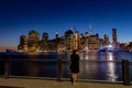 Lonely young woman standing on pier of the Granite prospect of Brooklyn Heights