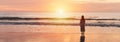 Lonely young woman walking and enjoying beautiful Sunset on the tranquil beach, Travel on summer vacation Royalty Free Stock Photo