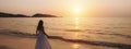 Lonely young woman walking and enjoying beautiful Sunset on the tranquil beach, Travel on summer vacation concept, Banner panorama Royalty Free Stock Photo