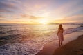 Lonely young woman walking and enjoying beautiful Sunset on the tranquil beach, Travel on summer vacation Royalty Free Stock Photo