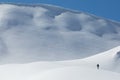 Lonesome women with snowshoes walking through snowy landscape