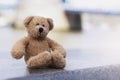 Loney teddy bear sitting by the river, The forgotten bear sitting alone, lost property, Lonely concept, Lost child, International Royalty Free Stock Photo