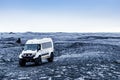 Long angle shot of a white tourist van on a gravel plain Royalty Free Stock Photo