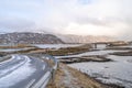 A long Atlantic Ocean winter Road and curved concrete bridge and water crossing from island in Lofoten. Royalty Free Stock Photo