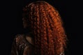 Long Auburn Afro Curls , Rear View On Black Background. Generative AI