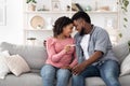 Long-Awaited Pregnancy. Black Couple Sitting Happy With Positive Result of Pregnancy Test