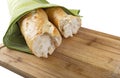 Long baguette broken into pieces on white background Royalty Free Stock Photo