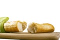 Long baguette broken into pieces on white background Royalty Free Stock Photo