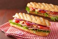 Long baguette sandwich with ham cheese tomato lettuce Royalty Free Stock Photo