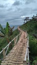 long bamboo bridge on the side of a steep and high hill Royalty Free Stock Photo