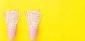 Long Banner Repeating Stacked Pink Drinking Paper Cups with Striped Straws on Yellow Background. Flat Lay Composition. Birthday Royalty Free Stock Photo