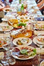 Long Banquet table. Drinks and snacks on the table.  People are sitting at the table. Concept of joint celebrations Royalty Free Stock Photo