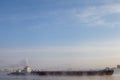 Long barge going down river in cold winter. Royalty Free Stock Photo