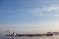 Long barge going down river in cold winter. Royalty Free Stock Photo