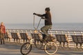 Long Beach, New York - 02/21/2018 : Man riding an oversized tall modified beach cruiser bike on Long Beach Boardwalk.