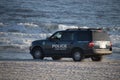 Long Beach, New York - 02/21/2018 : A Long Beach police vehicle cruising along the shore on the beach.