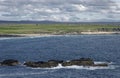 The long beach of Traigh Shanndaigh at the Butt of Lewis with scattered houses of the Crofting community .