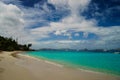 Long beach with yacht floating on the clear waters of the Caribbean Royalty Free Stock Photo