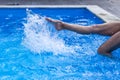 Foot of young women in water swimming pool, splashes from female legs. Royalty Free Stock Photo