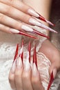 Long beautiful manicure with lace on female fingers. Nails design. Close-up Royalty Free Stock Photo