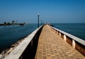 Long and beautiful almost never ending pier pointing to  the sea. Royalty Free Stock Photo