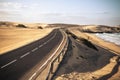 Long black asphalt road with desert and beach around for travel and adventure summer lifestyle concept with nobody traveling and