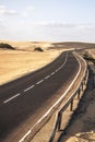 Long black asphalt road with desert and beach around for travel and adventure summer lifestyle concept with nobody traveling and