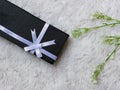 long black giftbox with white ribbon strap Royalty Free Stock Photo