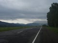 long black road in cloudy weather