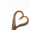 Long blond hair donation put like heart for cancer patient on white background. Top view. Natural material for making wig. Square