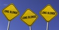 Long blonde - three yellow signs with blue sky background