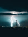 Long, branched, powerful lightning bolts strike down behind the trees. Dramatic lightning bolt. Royalty Free Stock Photo