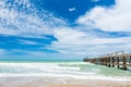 Long bridge on the beach with blue sky