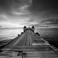 The long bridge over the sea with a beautiful sunrise in black a Royalty Free Stock Photo