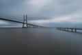 Long bridge over tagus river and pier in Lisbon at dawn Royalty Free Stock Photo