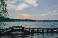 Long Bridge over West Lake with hills under sunset in the distance, in Hangzhou, China Royalty Free Stock Photo