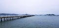 Long bridge among sea or ocean with many boat and white sky background at port Phuket, Thailand. Seascape view with mountain and N Royalty Free Stock Photo